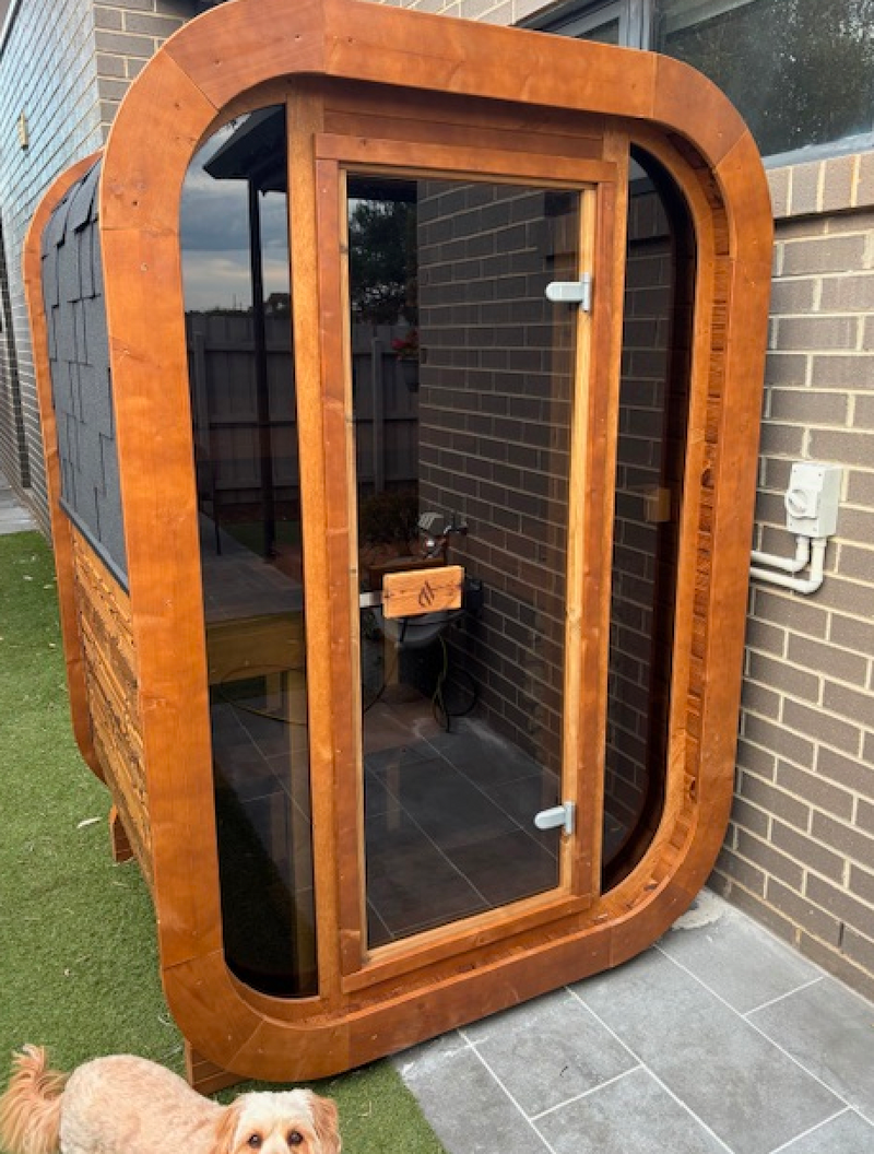 Easy side-of-house sauna, tucked against brickword.