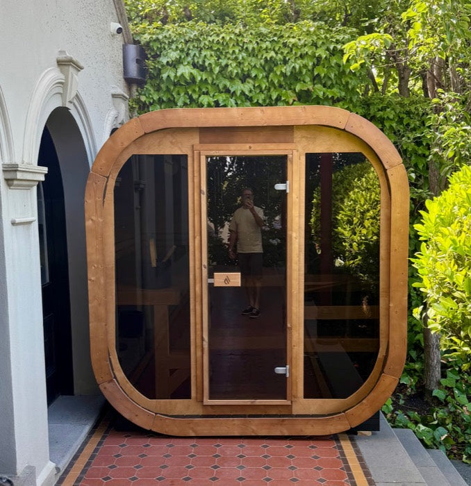 Timber sauna set in a tiled side passage beside a house